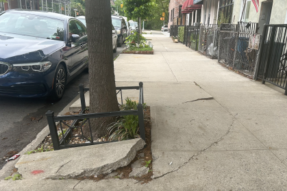 Broken sidewalk along Eighth Avenue in Brooklyn